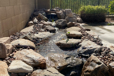 Design ideas for a mid-sized southwestern full sun backyard waterfall in Phoenix.