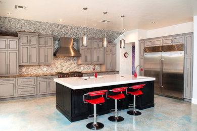 Inspiration for a mid-sized contemporary concrete floor and white floor open concept kitchen remodel in Other with a farmhouse sink, beaded inset cabinets, gray cabinets, quartz countertops, beige backsplash, matchstick tile backsplash, stainless steel appliances and an island
