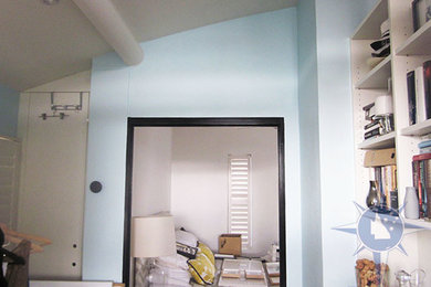 This is an example of a small contemporary bedroom in Brisbane with blue walls.