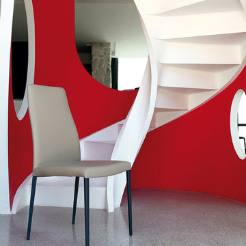 Modern spiral staircase in white with red accent wall