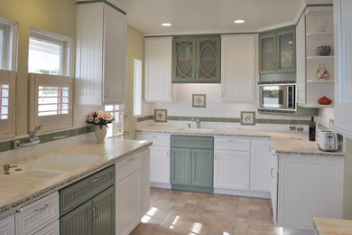 Inspiration for a timeless l-shaped ceramic tile enclosed kitchen remodel in Los Angeles with an integrated sink, solid surface countertops, subway tile backsplash, paneled appliances and no island