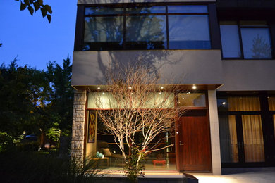 Inspiration for a large modern front yard concrete paver landscaping in Toronto.