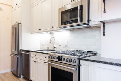 Kitchen pantry - mid-sized modern galley light wood floor and brown floor kitchen pantry idea in New York with a single-bowl sink, beaded inset cabinets, white cabinets, granite countertops, white backsplash, subway tile backsplash, stainless steel appliances and no island
