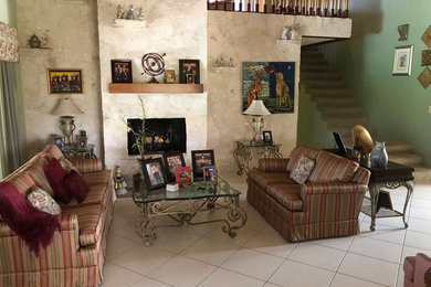 This is an example of a medium sized beach style enclosed living room in Miami with beige walls, ceramic flooring and white floors.
