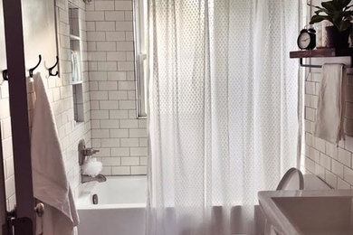 Small transitional 3/4 white tile and ceramic tile ceramic tile and black floor bathroom photo in Detroit with open cabinets, a two-piece toilet, white walls, a pedestal sink and solid surface countertops