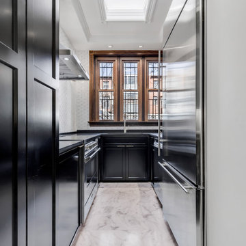 Two-Toned White and Dark Hunter Green Cabinets with Black Quartz Countertop