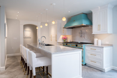 Inspiration for a small contemporary galley porcelain tile and gray floor enclosed kitchen remodel in Other with an undermount sink, shaker cabinets, white cabinets, quartz countertops, gray backsplash, quartz backsplash, colored appliances, an island and gray countertops