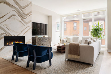Inspiration for a transitional family room remodel in Philadelphia with a standard fireplace and a stone fireplace