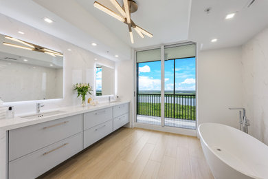 Inspiration for a contemporary master white tile and porcelain tile wood-look tile floor, brown floor and double-sink bathroom remodel in Other with shaker cabinets, gray cabinets, a two-piece toilet, white walls, an undermount sink, quartz countertops, a hinged shower door, white countertops and a floating vanity