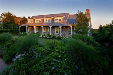 Example of a large beach style white two-story wood gable roof design in Boston