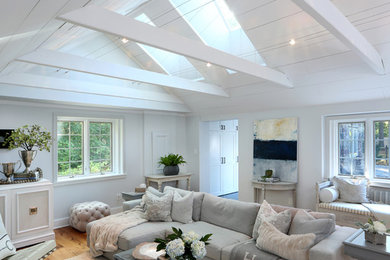 Photo of a large country open concept family room in Other with white walls and light hardwood floors.