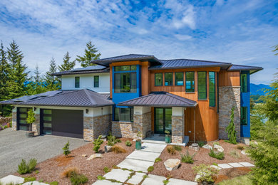 Inspiration for a large modern three-story mixed siding house exterior remodel in Seattle with a black roof