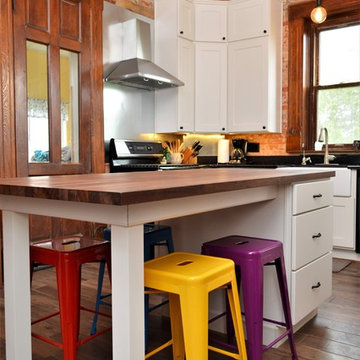 Bourbon, IN. Haas Signature Collection. Farmhouse Kitchen with Exposed Brick