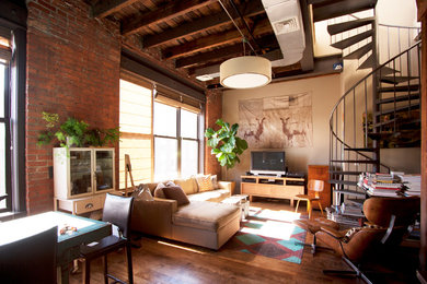 Inspiration for an industrial living room in New York with beige walls and a freestanding tv.