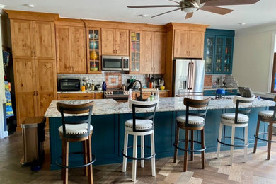 Example of an island style kitchen design in Other with an island