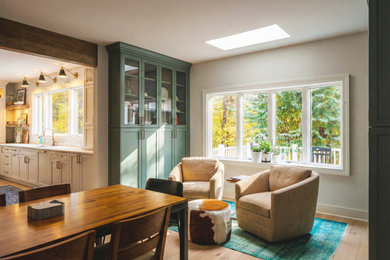 Large transitional light wood floor and brown floor kitchen/dining room combo photo in DC Metro with beige walls