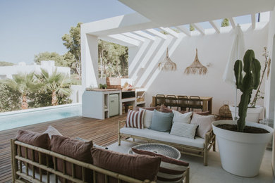 Inspiration for a coastal outdoor kitchen deck remodel in Alicante-Costa Blanca with a pergola