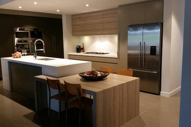 Inspiration for a contemporary kitchen in Sydney with quartz benchtops, white splashback and stainless steel appliances.