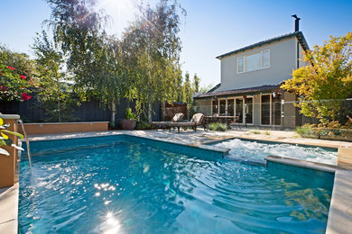 Small traditional backyard rectangular natural pool in Melbourne with a hot tub and natural stone pavers.