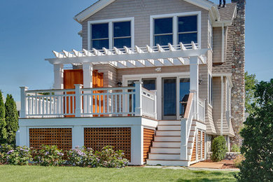Mid-sized traditional beige two-story stone exterior home idea in New York with a hip roof