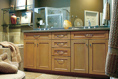 Mid-sized trendy master beige tile travertine floor drop-in bathtub photo in Orange County with light wood cabinets, gray walls, recessed-panel cabinets and quartzite countertops