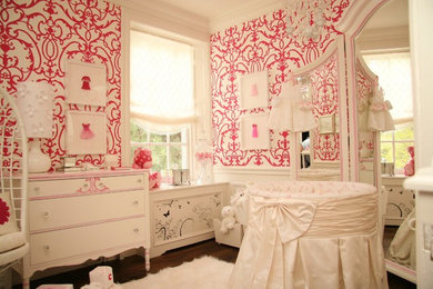 Mid-sized elegant girl dark wood floor nursery photo in Toronto with pink walls