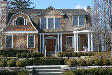 Photo of a large traditional two-storey brown house exterior in Detroit with wood siding.