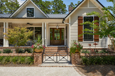 Coastal beige exterior home idea in Other with a metal roof