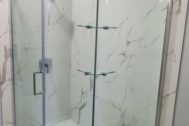 Corner shower - large contemporary master white tile and porcelain tile porcelain tile and white floor corner shower idea in Edmonton with white walls and a hinged shower door