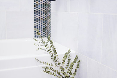 Example of a small minimalist 3/4 blue tile and marble tile marble floor and blue floor bathroom design in San Diego with flat-panel cabinets, gray cabinets, a two-piece toilet, blue walls, a vessel sink, quartz countertops, a hinged shower door and white countertops