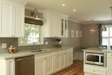 Eat-in kitchen - mid-sized transitional u-shaped light wood floor and brown floor eat-in kitchen idea in Atlanta with an undermount sink, recessed-panel cabinets, white cabinets, granite countertops, gray backsplash, ceramic backsplash, stainless steel appliances and a peninsula