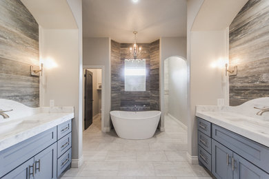 Bathroom - large transitional master beige tile and stone tile porcelain tile bathroom idea in Oklahoma City with shaker cabinets, gray cabinets, a two-piece toilet, gray walls, an undermount sink and marble countertops