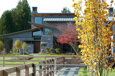Inspiration for a large contemporary two-story mixed siding exterior home remodel in Vancouver