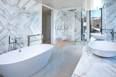 Example of a minimalist marble floor bathroom design in Denver with marble countertops