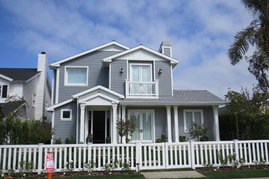 Inspiration for a large coastal gray two-story concrete fiberboard exterior home remodel in Orange County