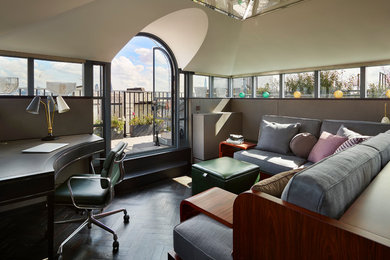 Photo of a small contemporary study in London with beige walls, dark hardwood flooring, a freestanding desk and black floors.