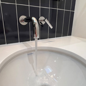 A Wall Mounted Faucet Adds to the Modern Spacious Design