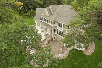 Transitional beige two-story exterior home idea in Minneapolis