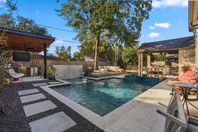 Inspiration for a large transitional backyard stone pool remodel in Houston