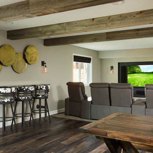 This is an example of a large traditional open plan home cinema in Minneapolis with grey walls, vinyl flooring and a wall mounted tv.