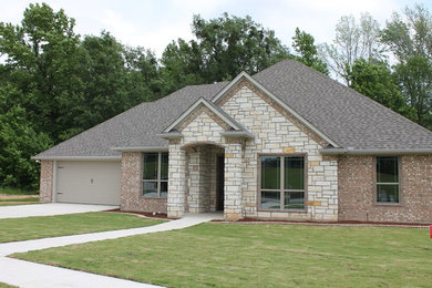 Example of a mid-sized classic gray one-story brick exterior home design in Austin