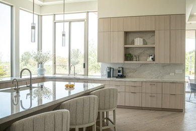 Inspiration for a large contemporary u-shaped eat-in kitchen remodel in Las Vegas with an island