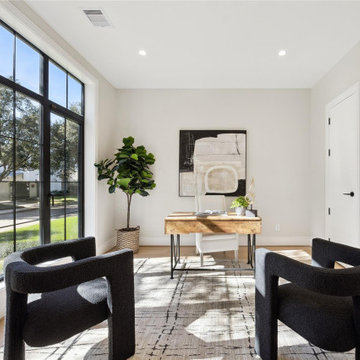 Light-filled sitting room with floor-to-ceiling steel windows