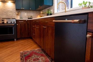 Eat-in kitchen - mid-sized 1950s l-shaped vinyl floor and brown floor eat-in kitchen idea in DC Metro with an undermount sink, flat-panel cabinets, dark wood cabinets, quartz countertops, gray backsplash, porcelain backsplash, black appliances, an island and white countertops