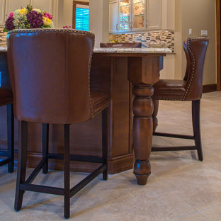 Large traditional kitchen pantry appliance - Example of a large classic ceramic floor kitchen pantry design in Philadelphia with an undermount sink, recessed-panel cabinets, white cabinets, granite countertops, beige backsplash, mosaic tile backsplash, stainless steel appliances and an island