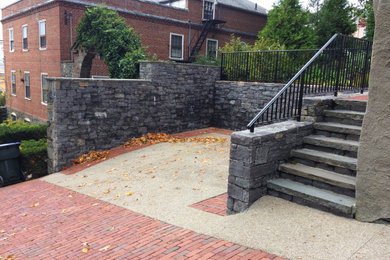 This is an example of a small traditional full sun courtyard brick landscaping in Providence.