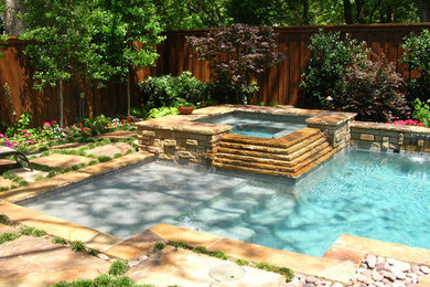 Inspiration for a mid-sized rustic backyard stone and rectangular hot tub remodel in Dallas