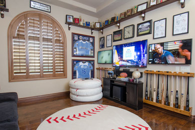 Elegant enclosed dark wood floor home theater photo in Phoenix with beige walls and a wall-mounted tv