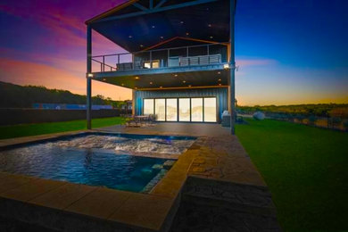 Example of a trendy concrete paver and rectangular water slide design in Dallas