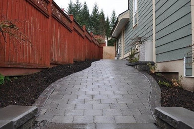 Photo of a large traditional shade side yard concrete paver garden path in Edmonton.